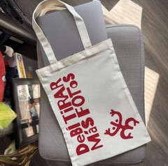 Beige Canvas Foldable Tote Bag with Red Spanish Text and All-Over Pattern